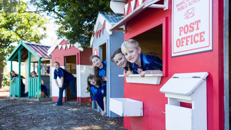 Students in playground cubby houses
