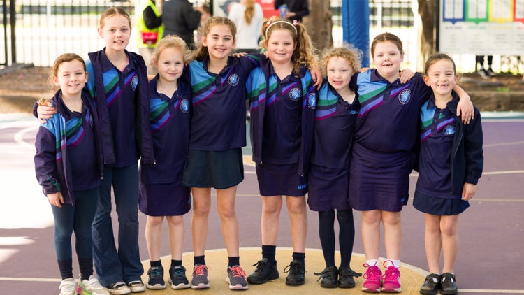 Eight students standing in a line